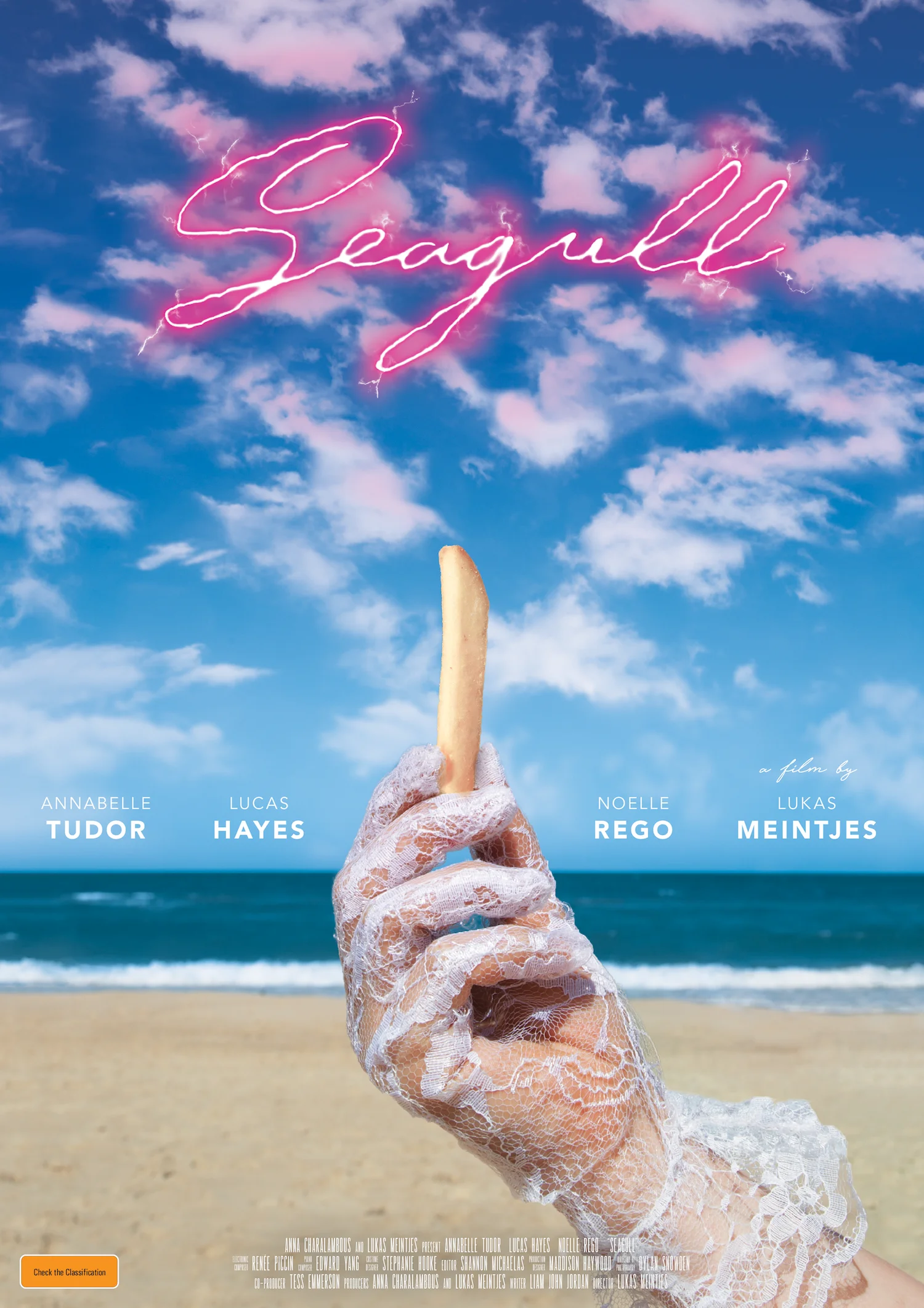 the films' poster: an lace gloved hand holds up a chip, a beach is in the background, the clouds look like a seagull